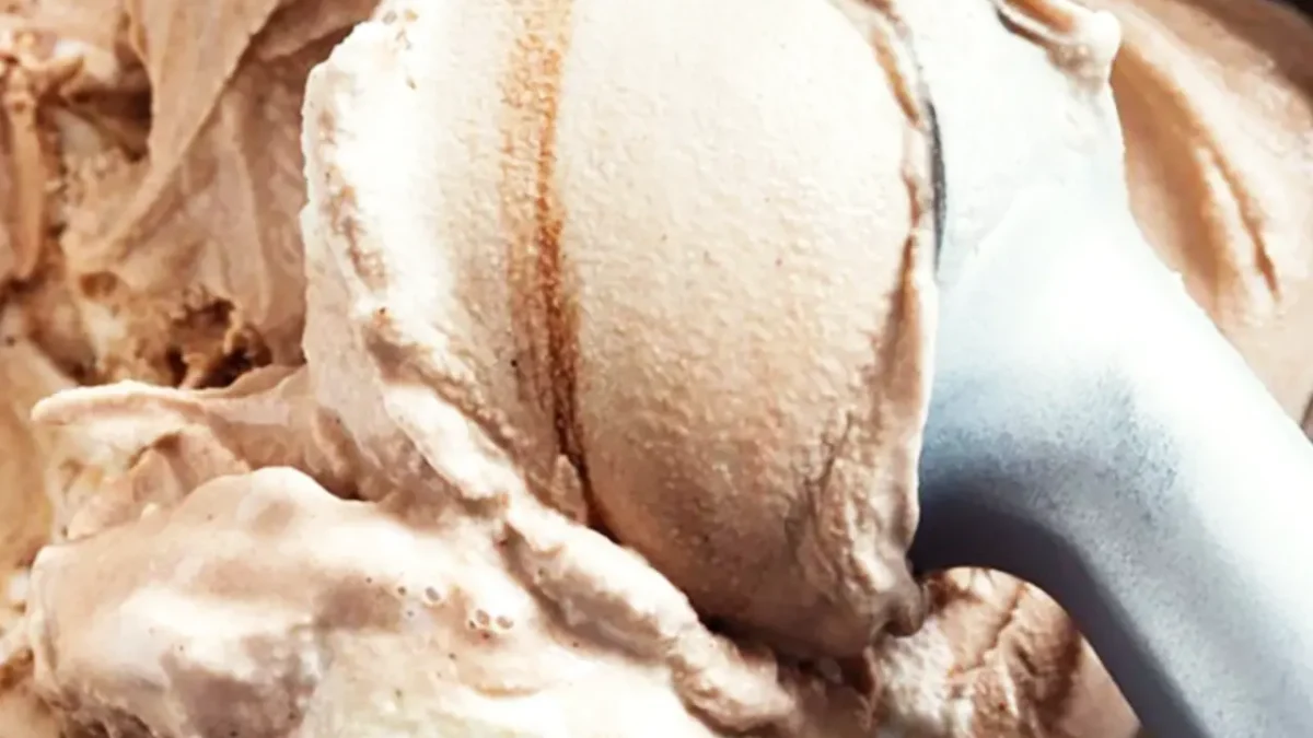 Close-up of chocolate ice cream being scooped, perfect for keeping cold with dry ice.