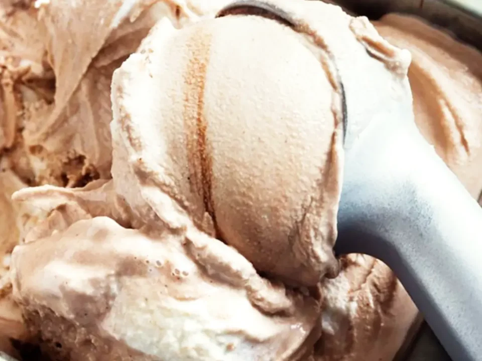 Close-up of chocolate ice cream being scooped, perfect for keeping cold with dry ice.