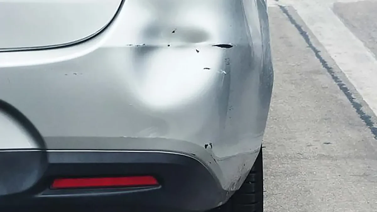 Rear bumper with significant dent damage. Dry ice dent removal may be needed.