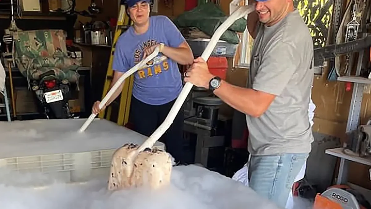 Couple making ice cream using dry ice in a garage.