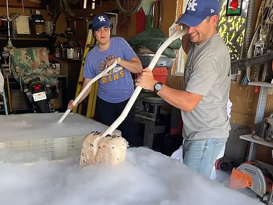 Couple making ice cream using dry ice in a garage.